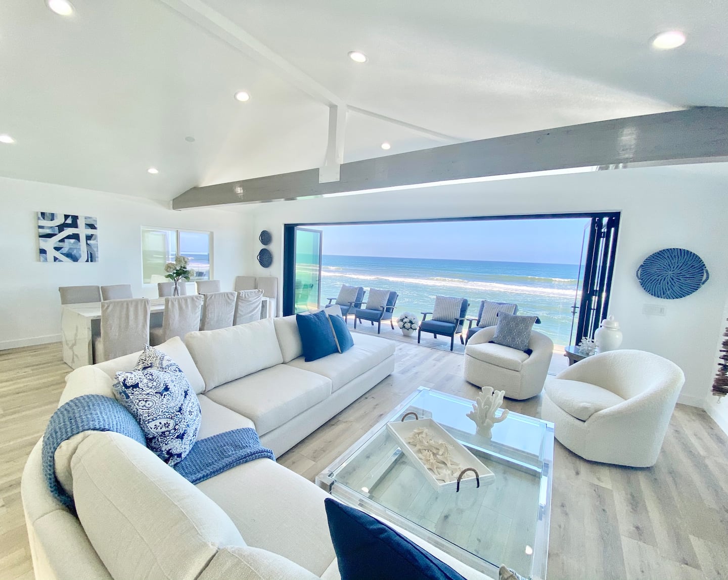 White sectional seating in the great room facing the water